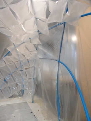 The inflated thermal pouches we connected inside the greenhouse to the pipework structure.